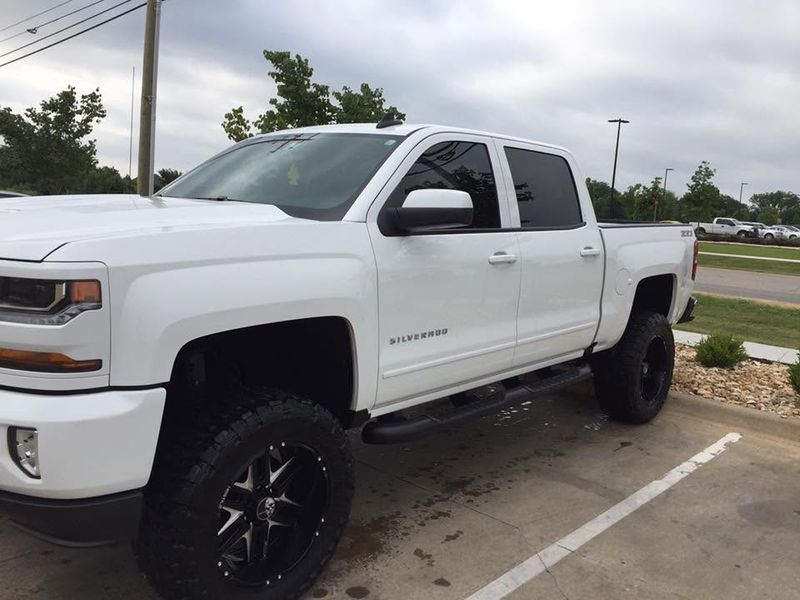 The same white Chevy Silverado clean and glossy after its wash